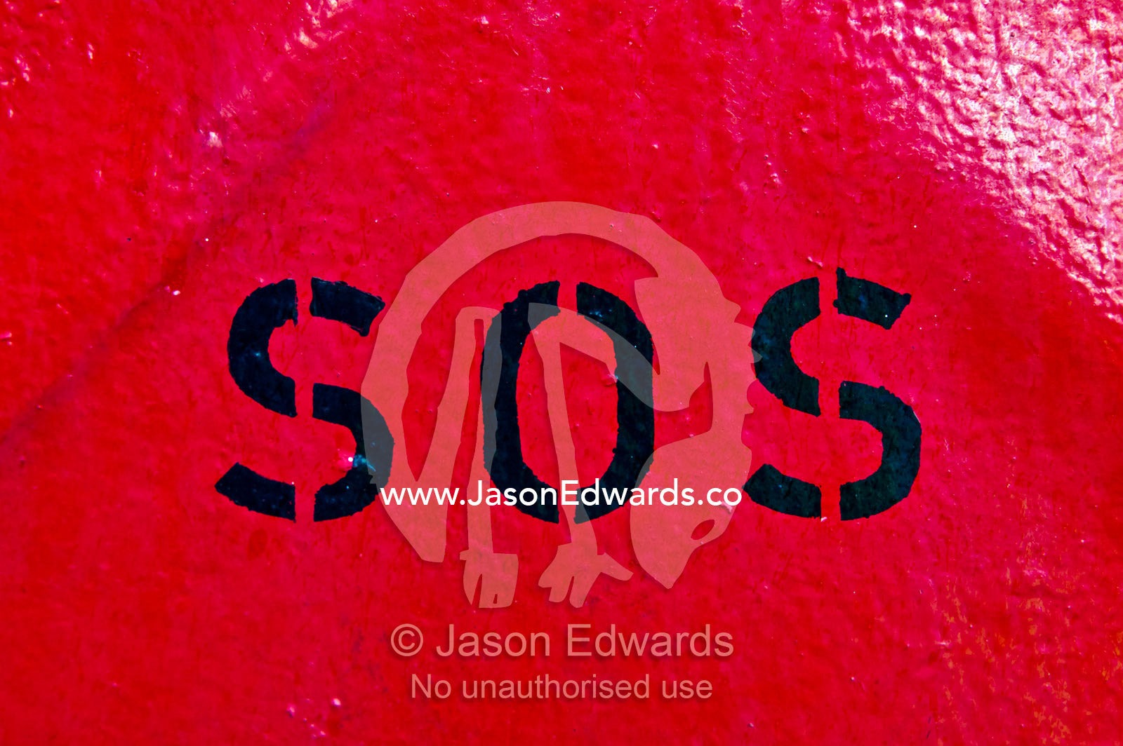Emergency SOS stencil sign on a bright red steel wall on a cargo ship. Appleton Dock, Port of Melbourne, West Melbourne, Victoria, Australia.