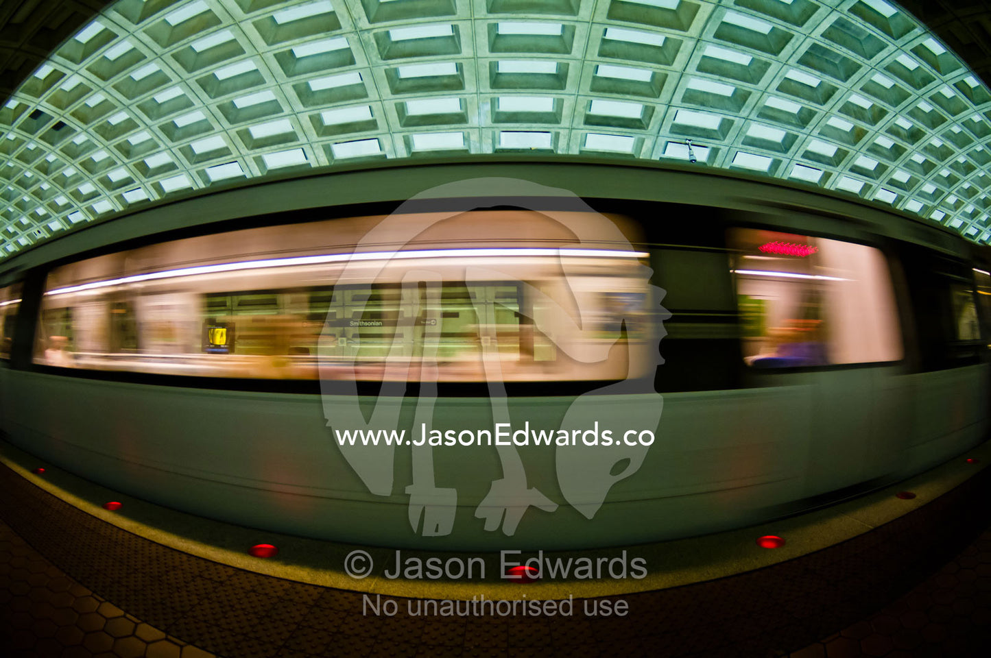 A Metro train speeds past a platform in a concrete subway tunnel. Washington Metropolitan Area Transit Authority, Washington, District of Columbia, United States of America.