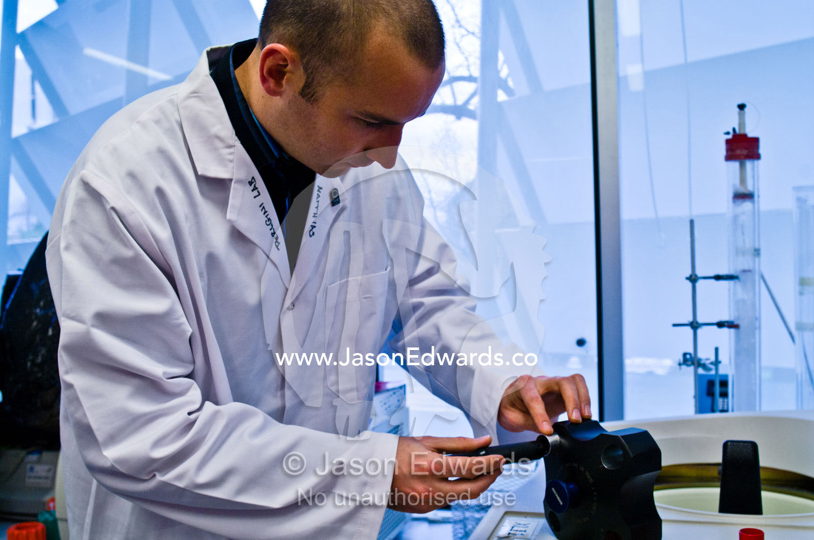Scientists load an analytical centrifuge to prepare protein samples. Bio21 Molecular Science and Biotechnology Institute, University of Melbourne, Parkville, Melbourne, Victoria, Australia.