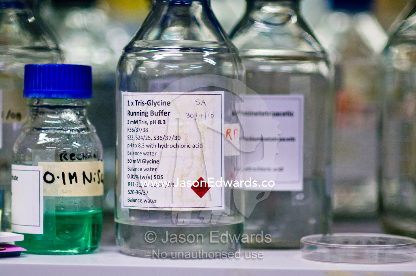 Jars of Nickel solution and a buffer solution used for experiments. Bio21 Molecular Science and Biotechnology Institute, University of Melbourne, Parkville, Melbourne, Victoria, Australia.
