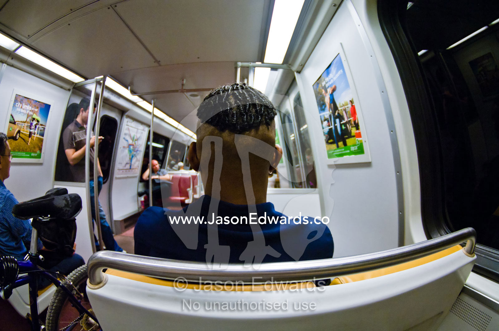 Passengers ride a train through a darkened subway tunnel. Washington Metropolitan Area Transit Authority, Washington, District of Columbia, United States of America.