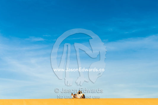 A film crew records an interview on a coastal sand dune at sunset. Cape Range National Park, Exmouth, Ningaloo Reef, Western Australia, Australia.