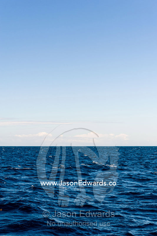 A calm ocean surface stretching all the way to the horizon. Exmouth, Ningaloo Reef, Ningaloo Marine Park, World Heritage Site, Western Australia, Australia.