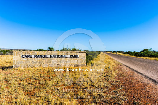 A sign indicates you are entering a protected desert National Park. Cape Range National Park, Exmouth, Ningaloo Reef, Western Australia, Australia.