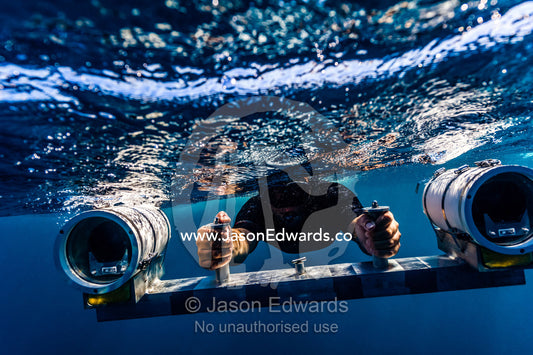 A scientist uses a stereo video camera to measure a Whale Shark's length. Exmouth, Ningaloo Reef, Ningaloo Marine Park, Western Australia, Australia.