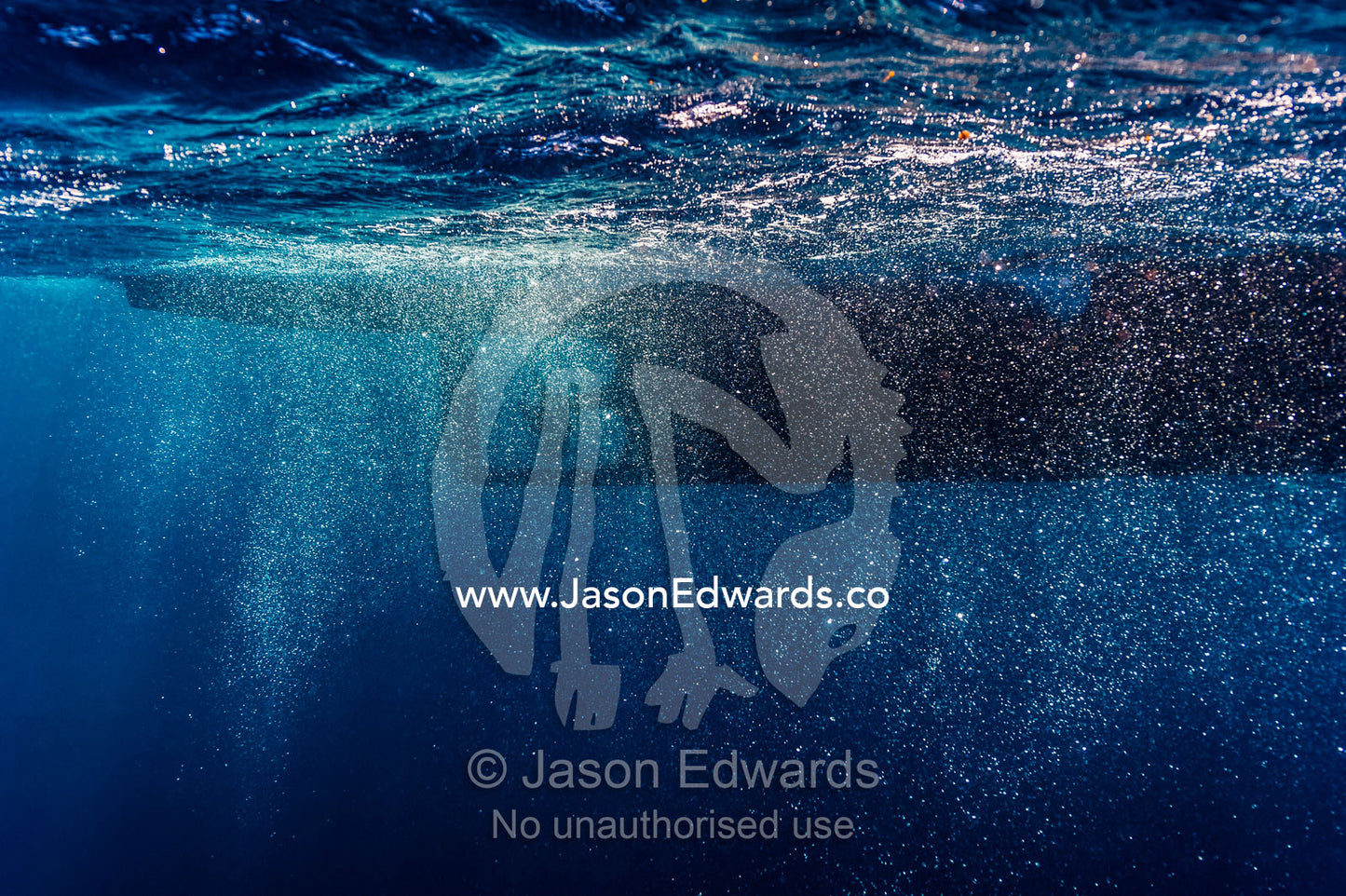 Bubbles swirling around a boat propeller below the ocean surface. Exmouth, Ningaloo Reef, Ningaloo Marine Park, Western Australia, Australia.