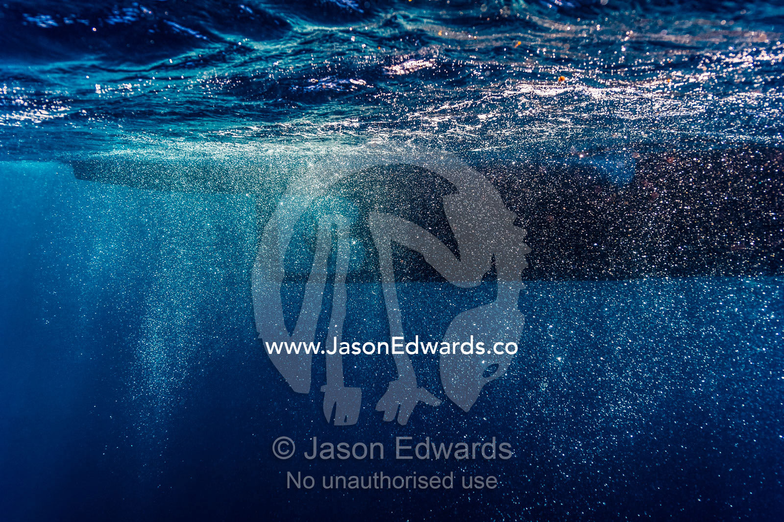 Bubbles swirling around a boat propeller below the ocean surface. Exmouth, Ningaloo Reef, Ningaloo Marine Park, Western Australia, Australia.