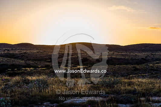 Dawn rising over an arid rocky coastal desert in Big Sky Country. Cape Range National Park, Exmouth, Ningaloo Reef, Western Australia, Australia.
