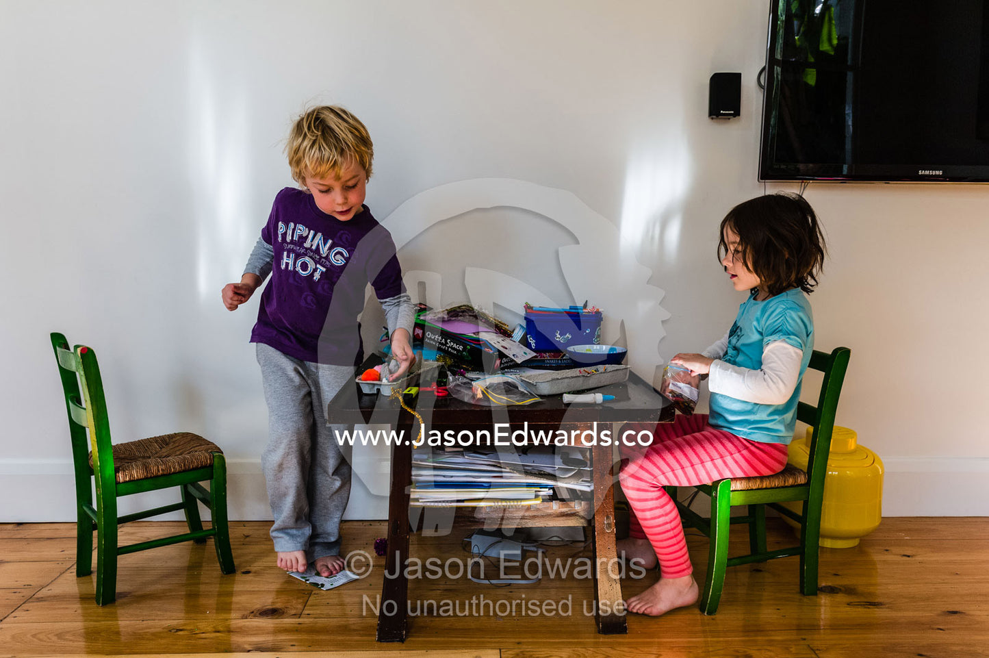 Youngs friends make fun creations on and arts and crafts table. North Carlton, Melbourne, Victoria, Australia.