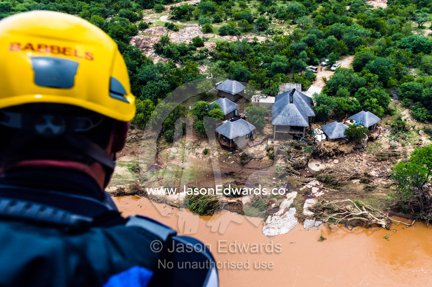 An airforce rescue crew surveys flood damage to a safari lodge. Kruger National Park, South Africa.