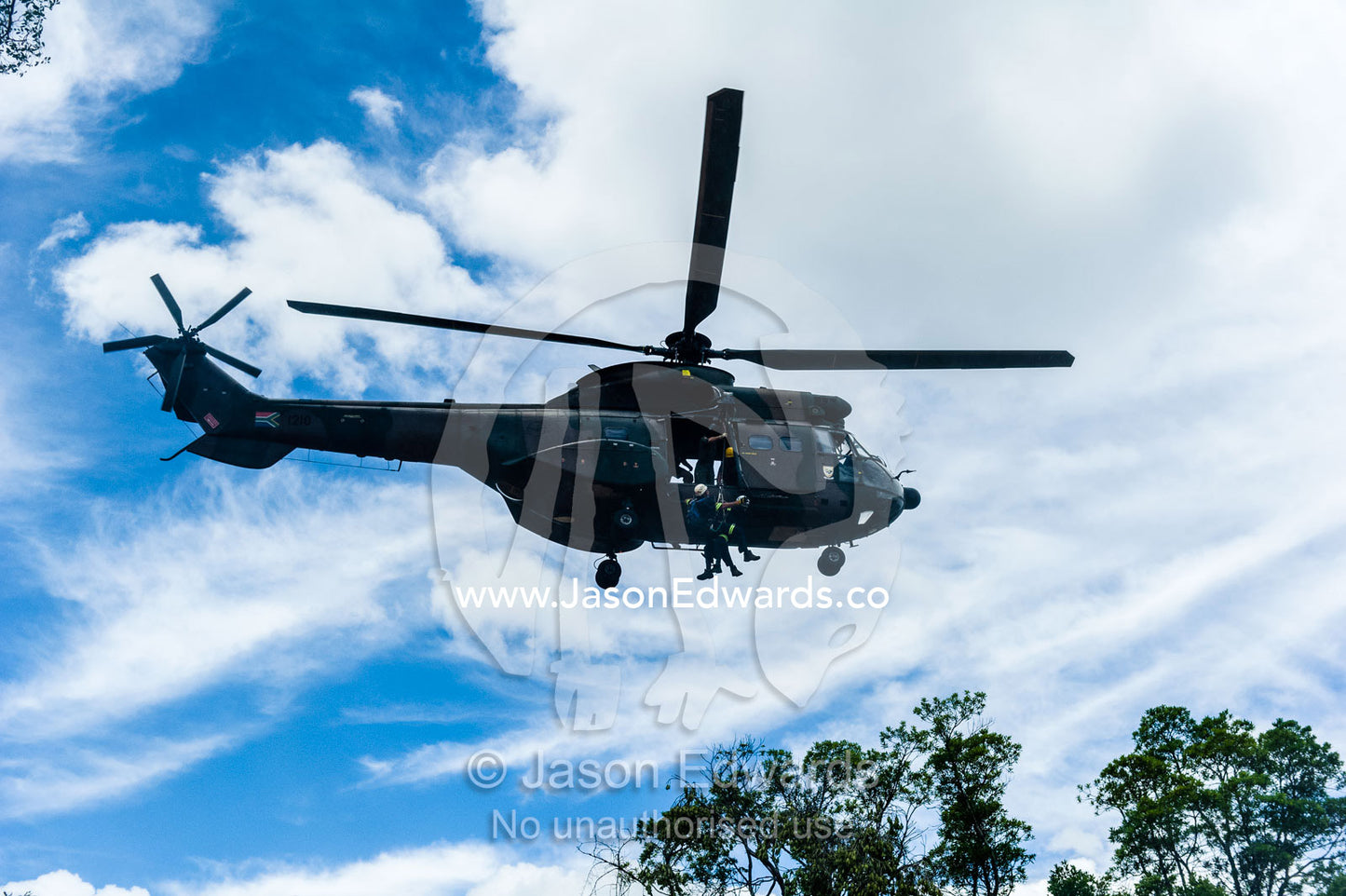 Airforce and police rescue crew lowered from an Atlas Oryx helicopter. Kruger National Park, South Africa.