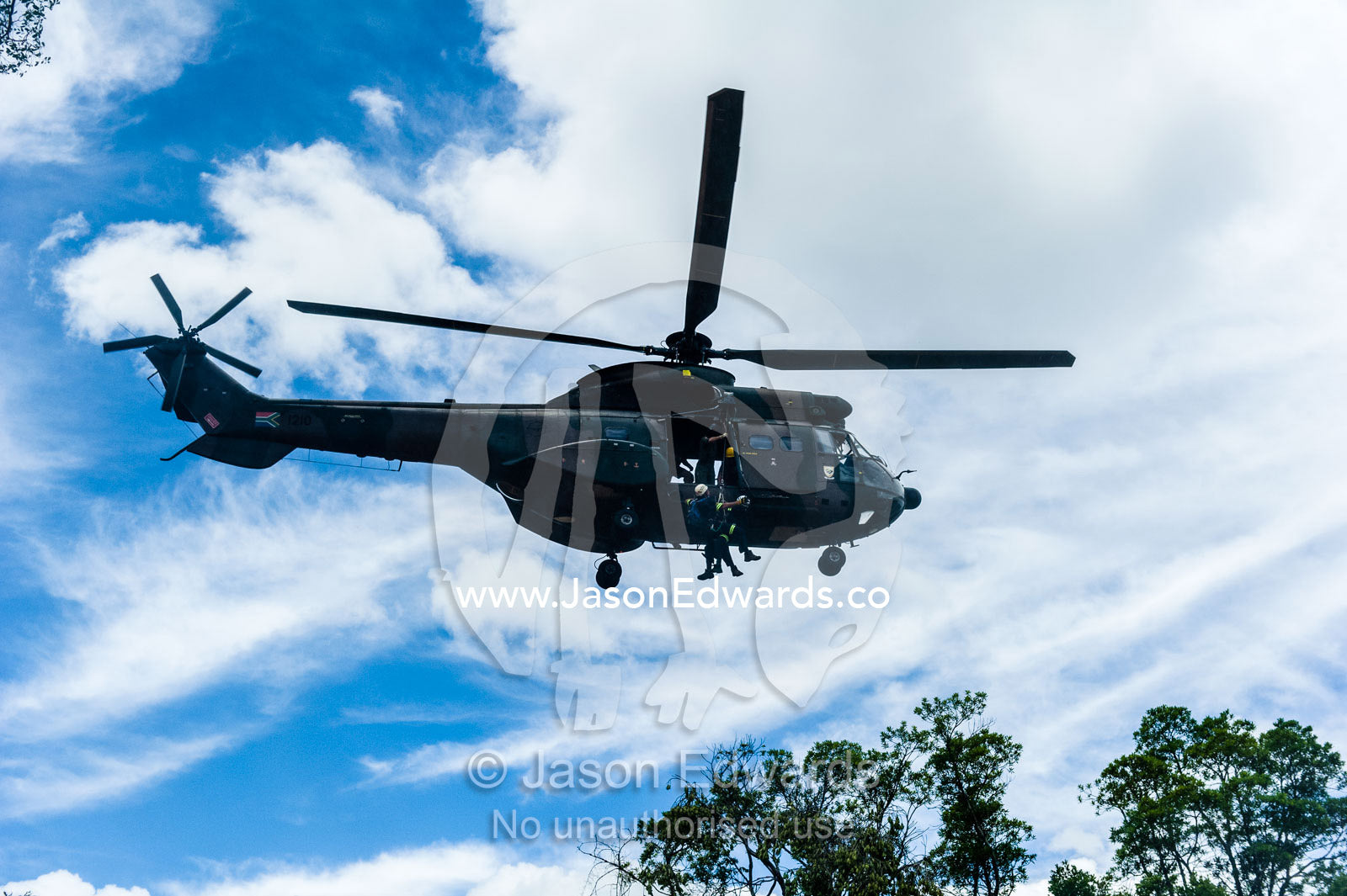 Airforce and police rescue crew lowered from an Atlas Oryx helicopter. Kruger National Park, South Africa.