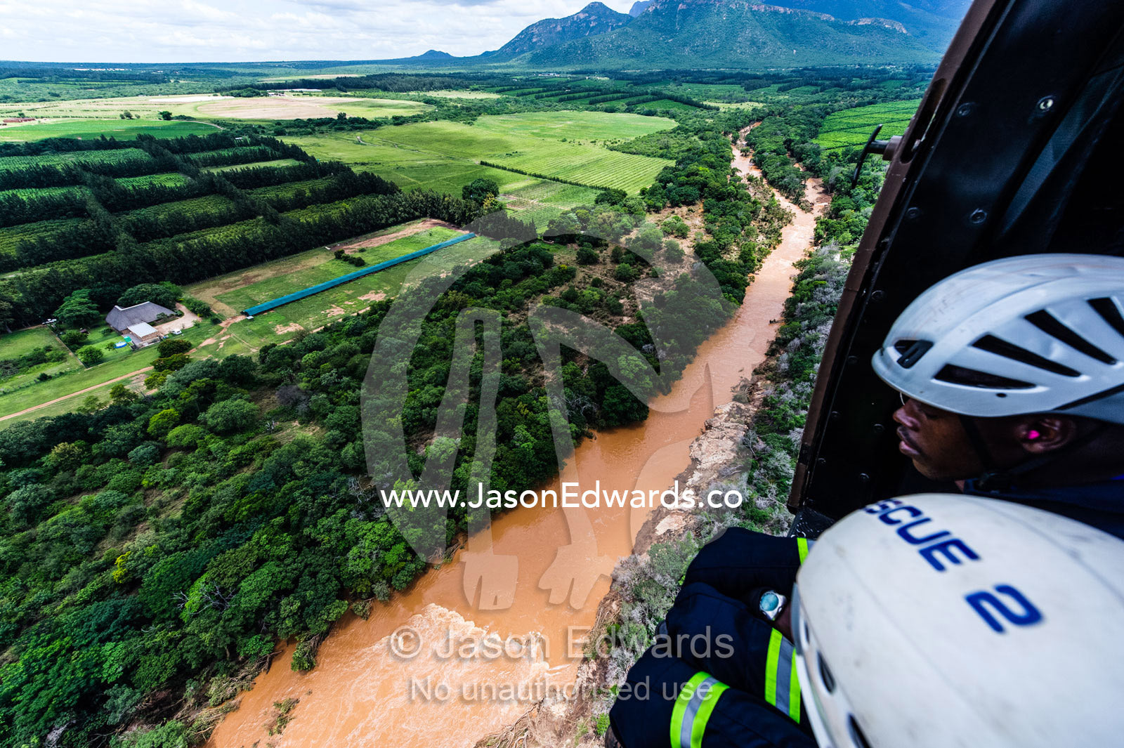 Police and airforce crew search for trapped survivors in flood waters. Kruger National Park, South Africa.