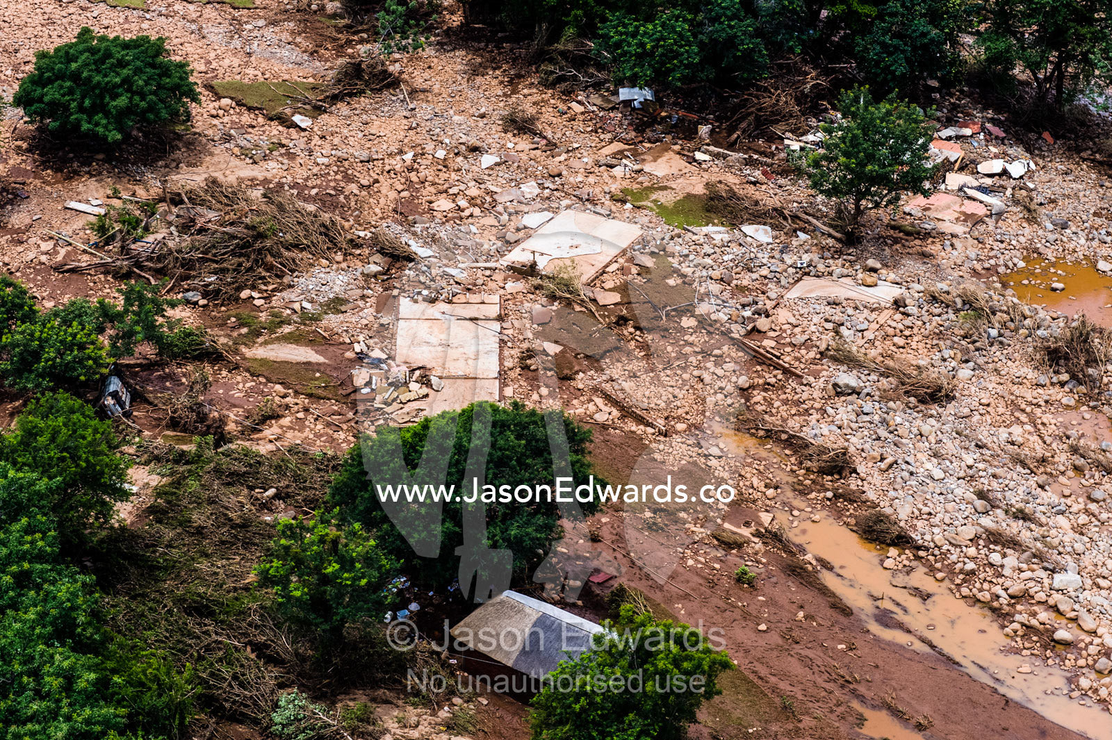 A village on a savannah plain destroyed by raging flood waters. Kruger National Park, South Africa.