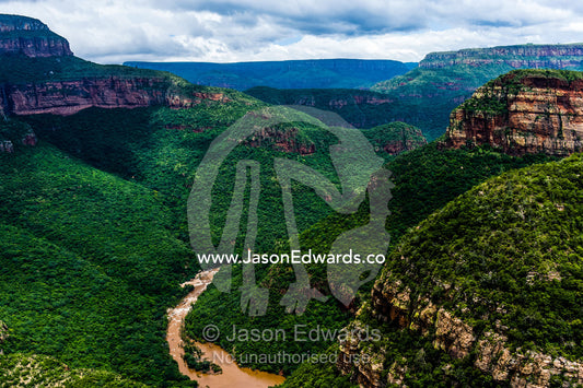 A river carves its way through a gorge shrouded in primeval forest. Blyde River Canyon, South Africa.