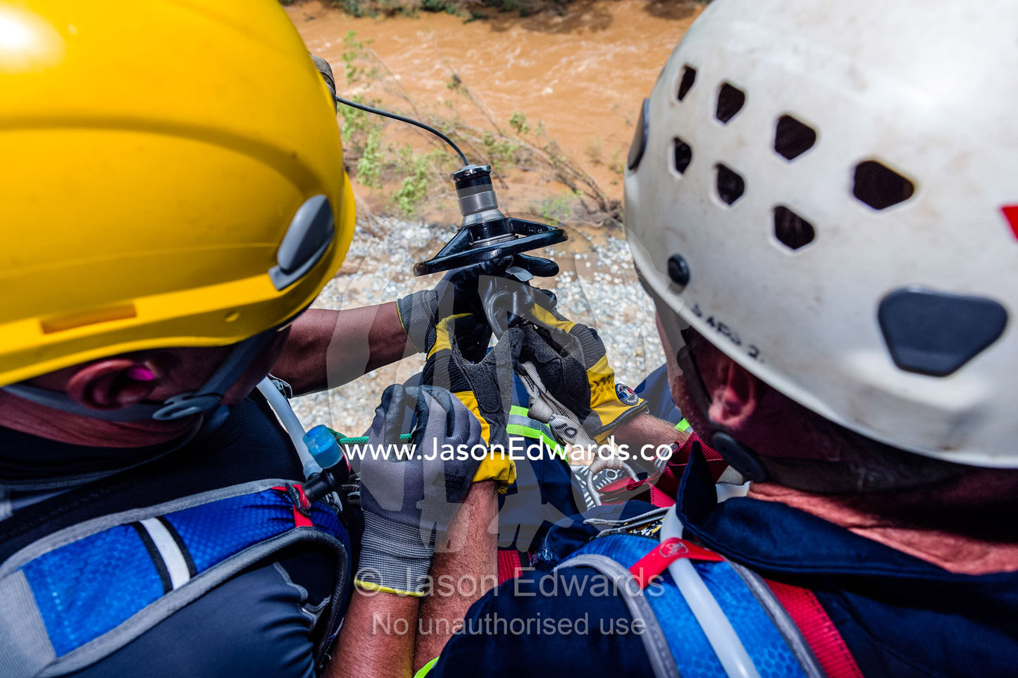 Airforce and police rescue team descend on a winch to a flooded river. Kruger National Park, South Africa.