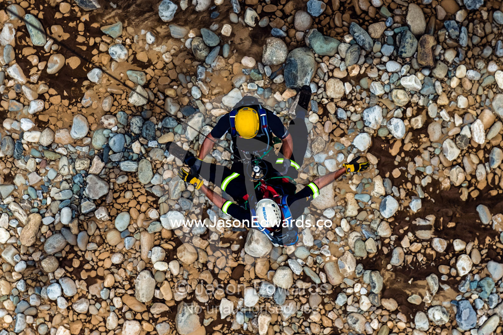 Airforce and police rescue team descends on a winch to a rocky slope. Kruger National Park, South Africa.