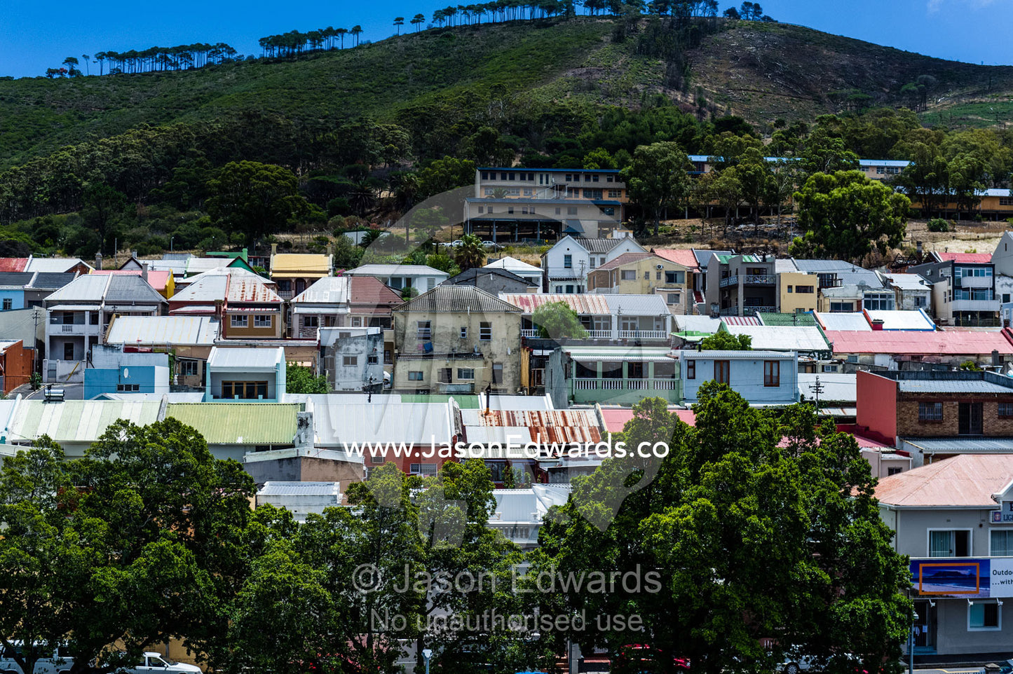 A crowded low-income suburb nestled next to a freeway overpass. Cape Town, Western Cape, South Africa.