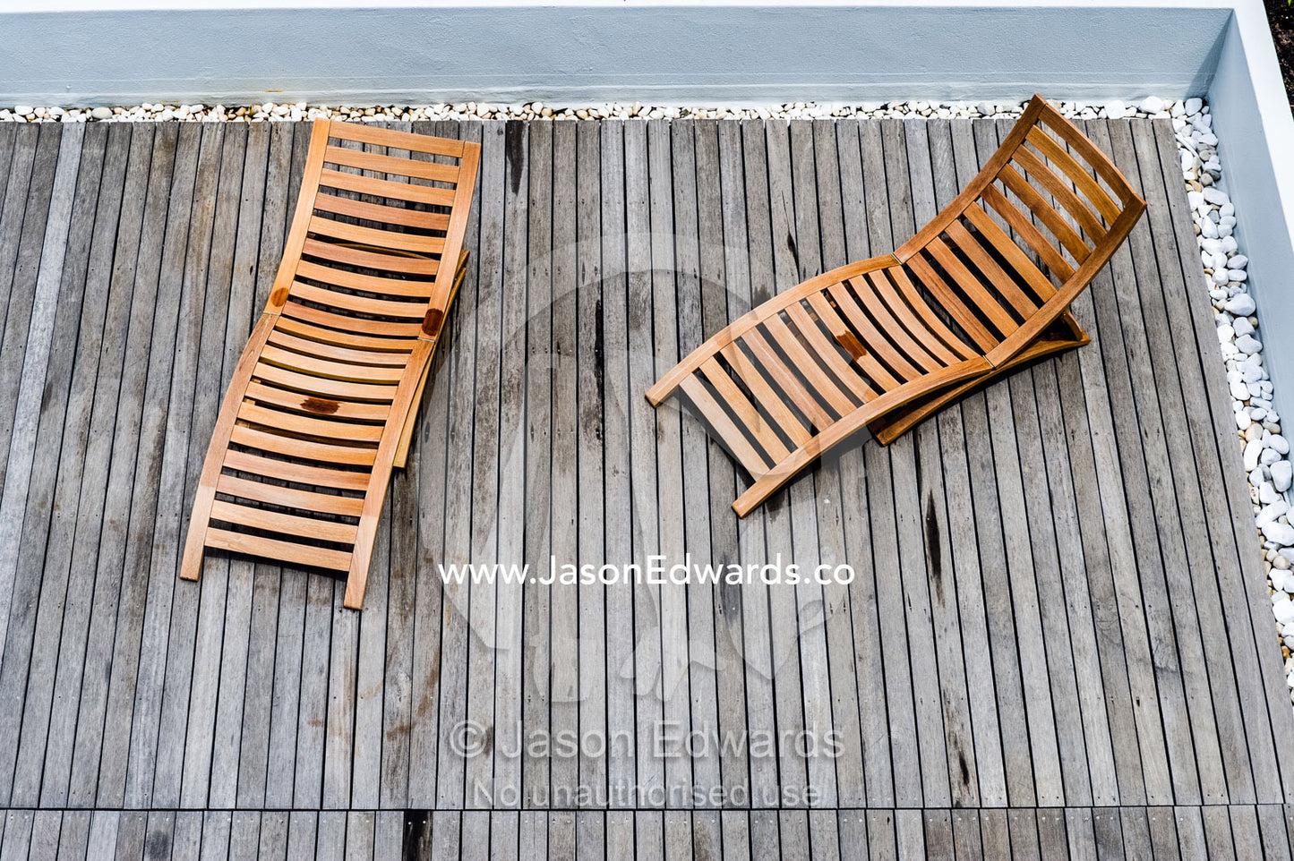 Timber deck chairs in a rooftop garden on an apartment complex. Cape Town, Western Cape, South Africa.