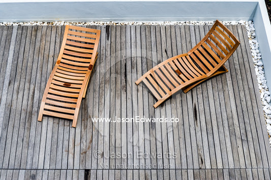Timber deck chairs in a rooftop garden on an apartment complex. Cape Town, Western Cape, South Africa.