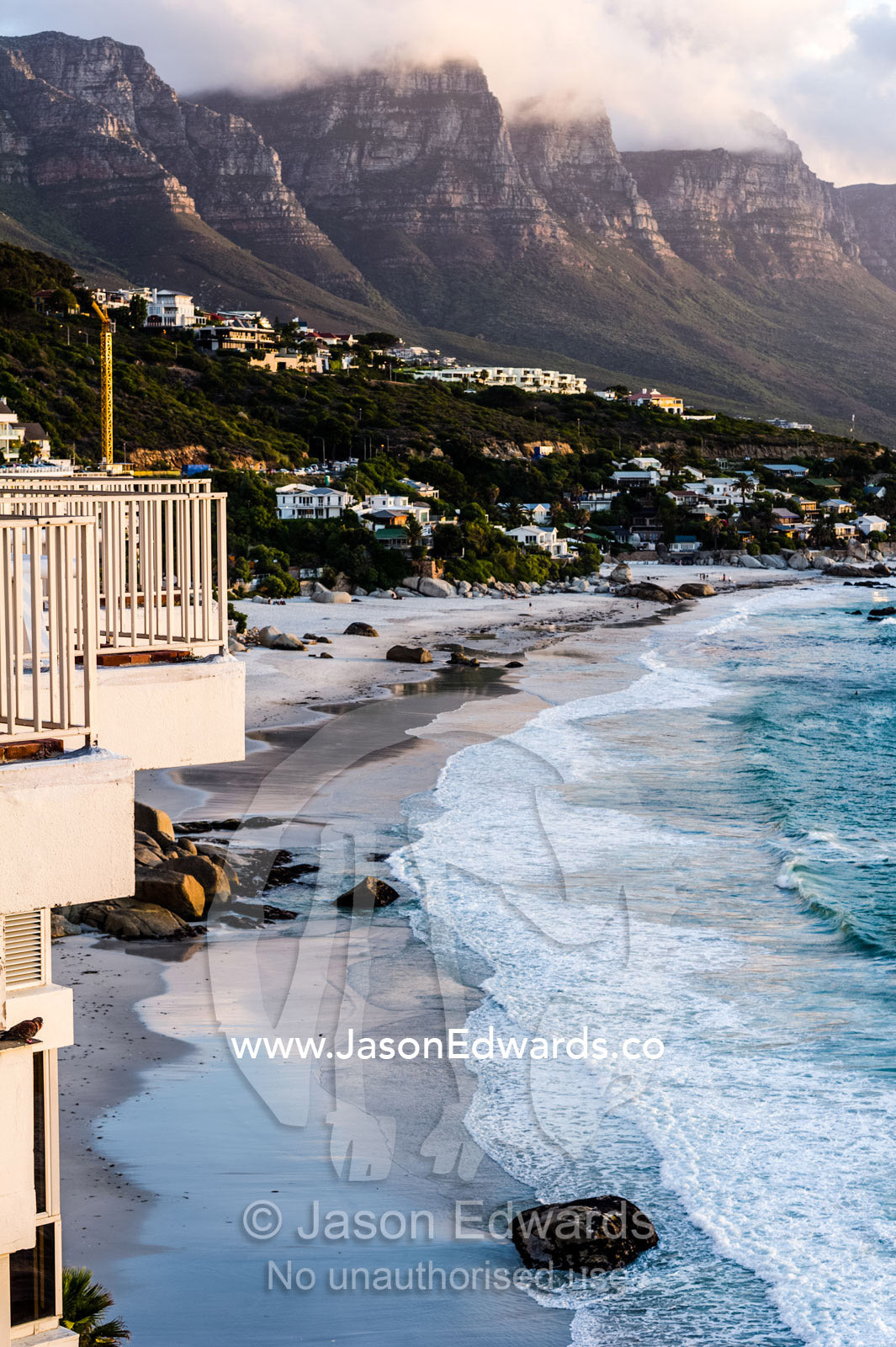 Holiday apartment balconies overlooking the ocean at sunset. Clifton Beach, Chapman's Peak Mountain Range, Cape Town, Western Cape, South Africa.