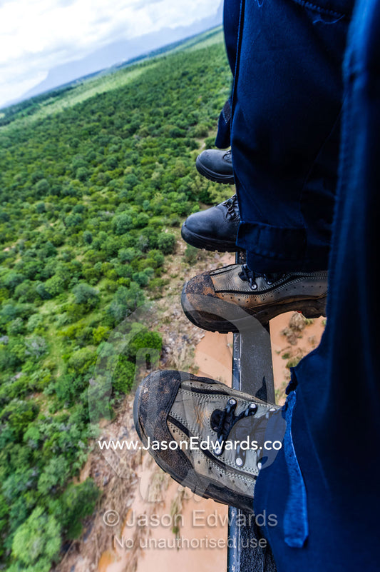 Police and Airforce rescue crew boots in an Atlas Oryx helicopter. Kruger National Park, South Africa.