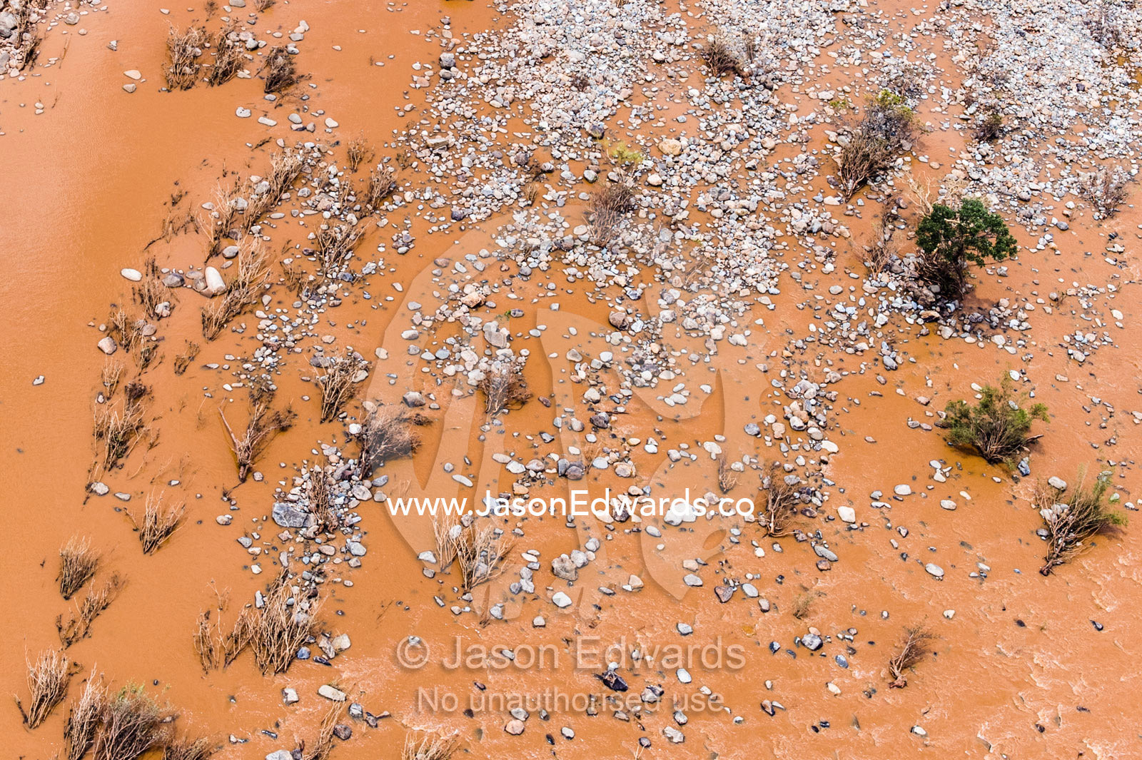 Boulders and rubble strewn across a plain by flood waters. Kruger National Park, South Africa.