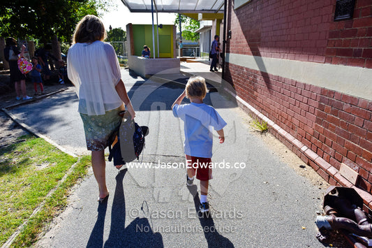 A mother walks her son to the classroom on his first day of school. Melbourne, Carlton North, Melbourne, Victoria, Australia.
