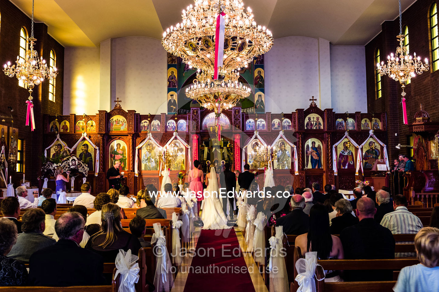 A bride and groom give their vows during a Greek Orthodox wedding. Melbourne, Victoria, Australia.