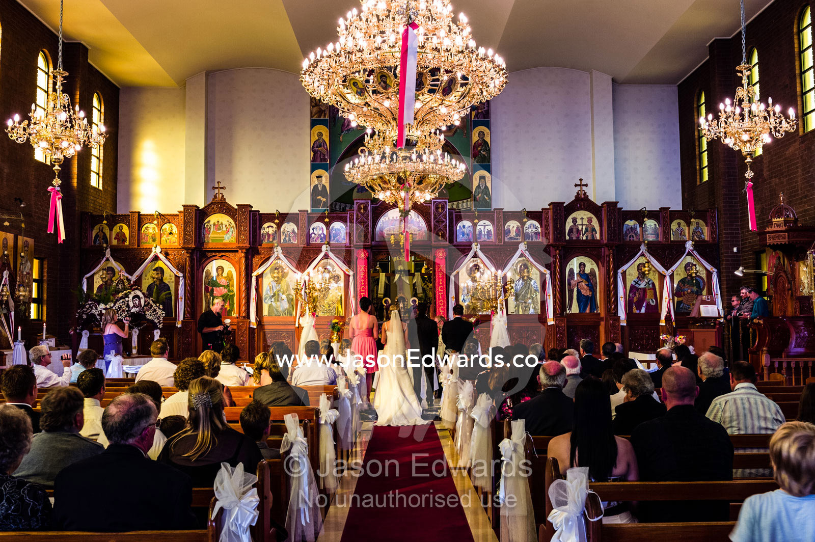 A bride and groom give their vows during a Greek Orthodox wedding. Melbourne, Victoria, Australia.