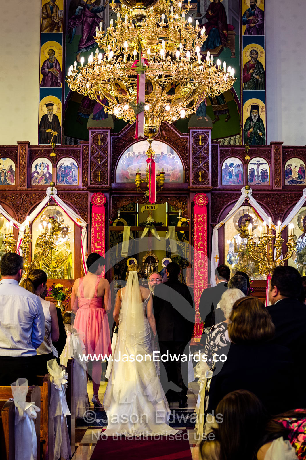 Guests join in prayers and celebrations at a Greek Orthodox wedding. Melbourne, Victoria, Australia.