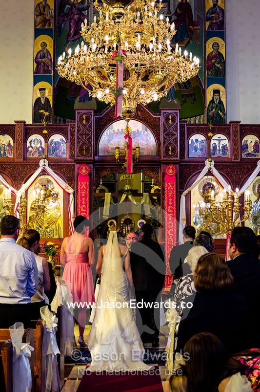 Guests join in prayers and celebrations at a Greek Orthodox wedding. Melbourne, Victoria, Australia.