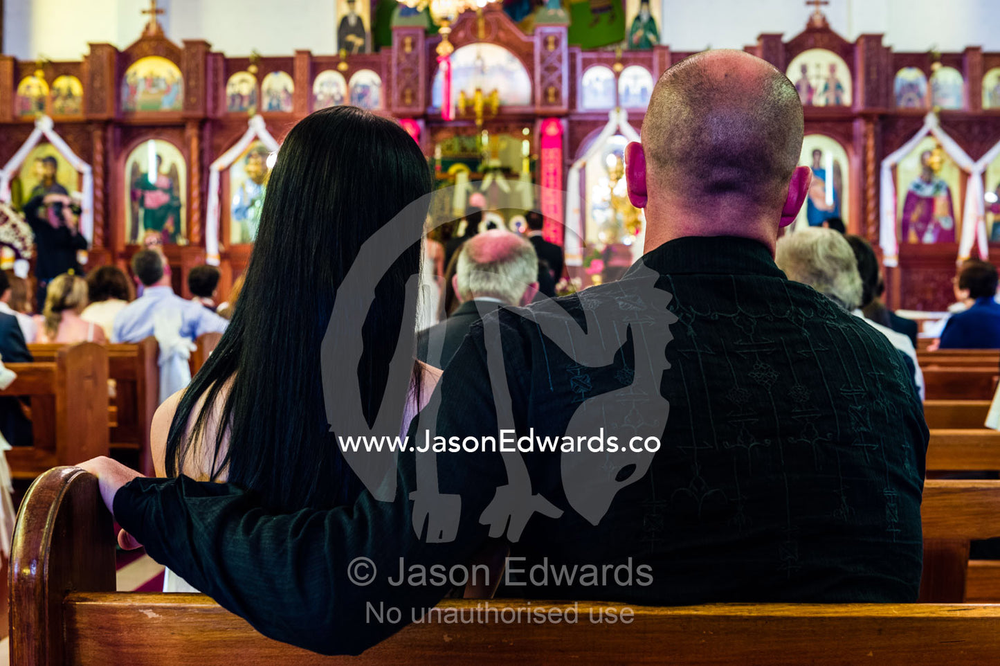 Guests join in prayers and celebrations at a Greek Orthodox wedding. Melbourne, Victoria, Australia.