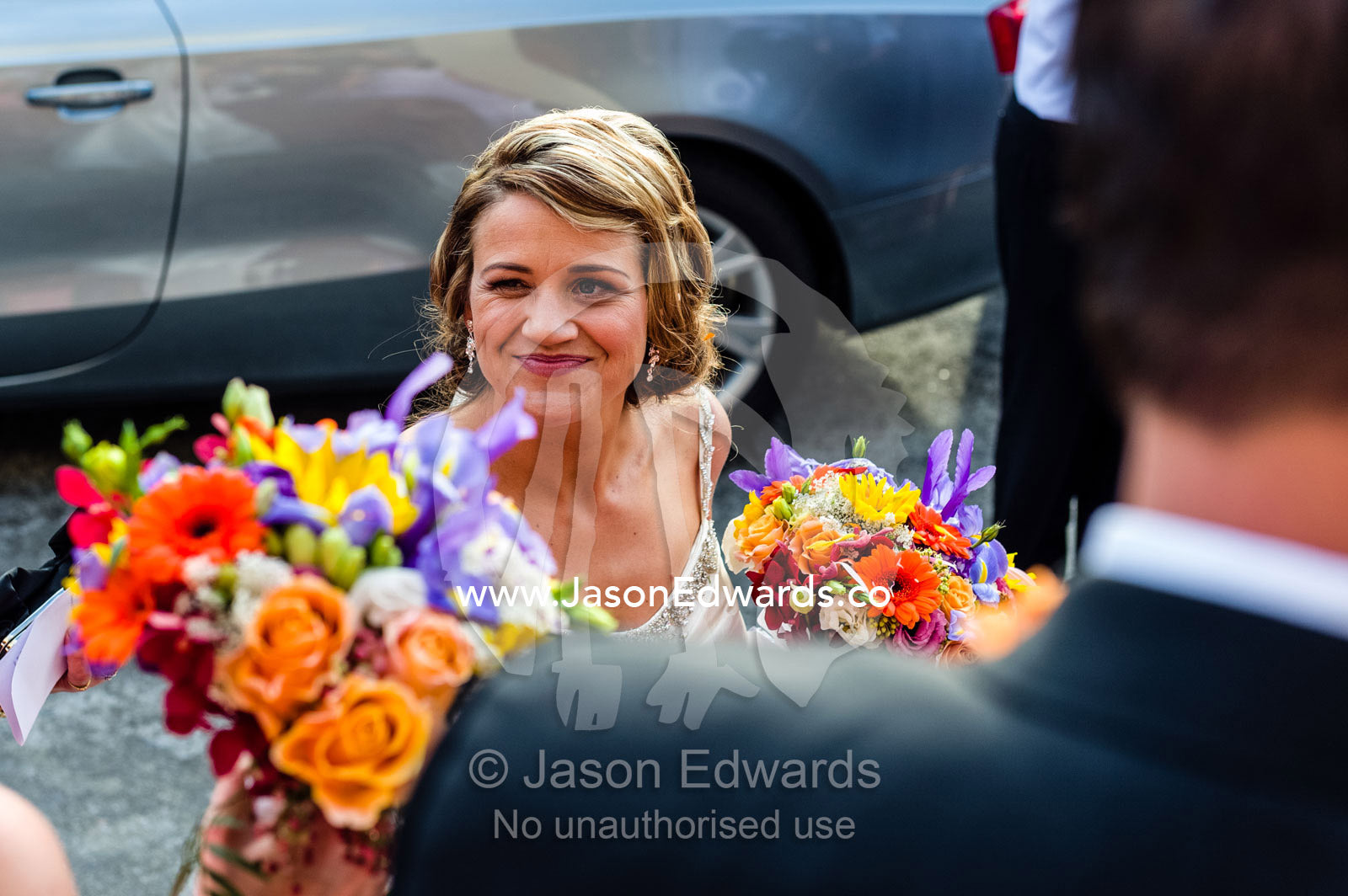 A happy, blushing bride with her bouquet at a Greek Orthodox wedding. Melbourne, Victoria, Australia.