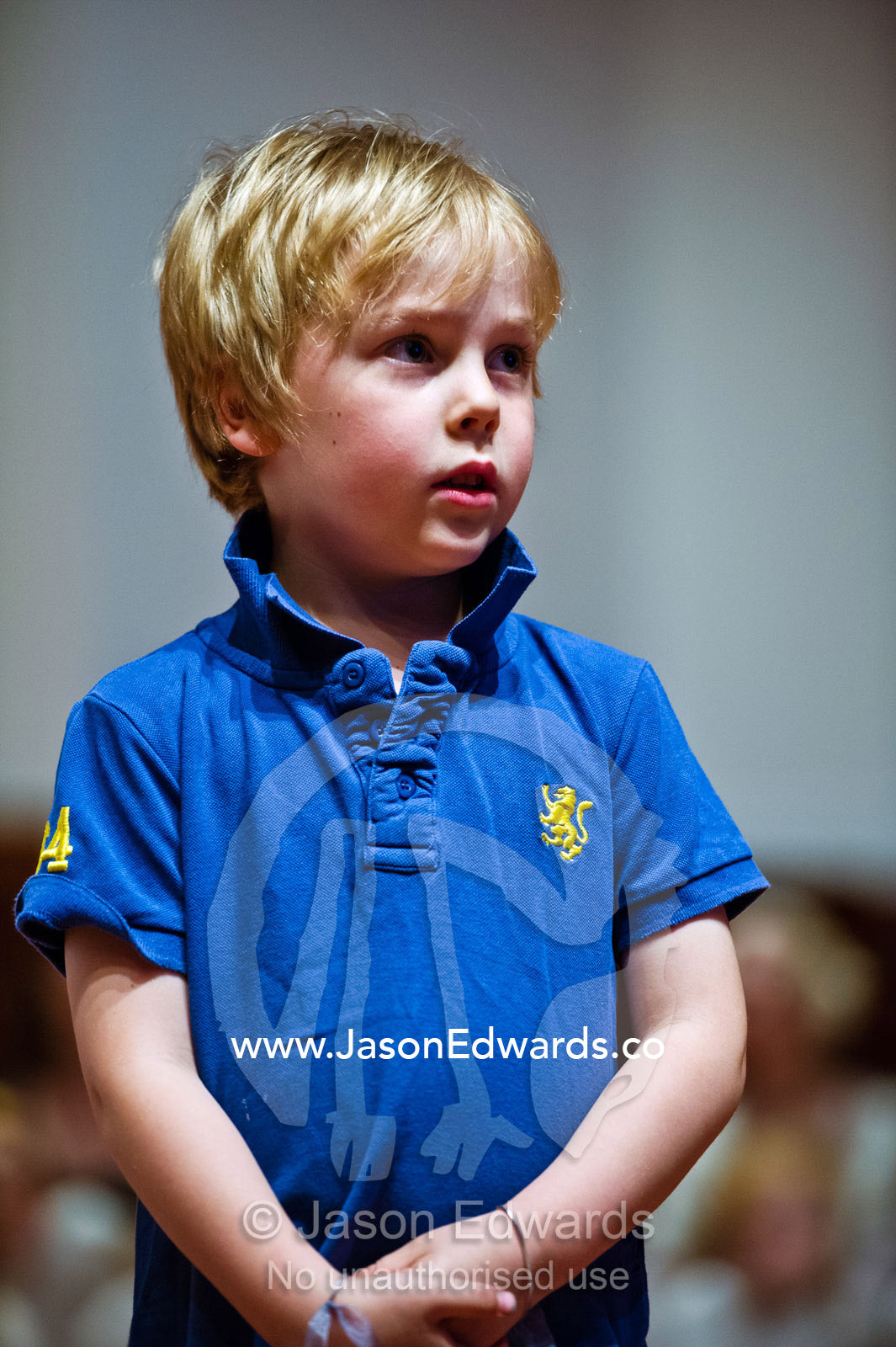 A boy concentrates whilst performing in a kindergarden school play. Kew, Melbourne, Victoria, Australia.