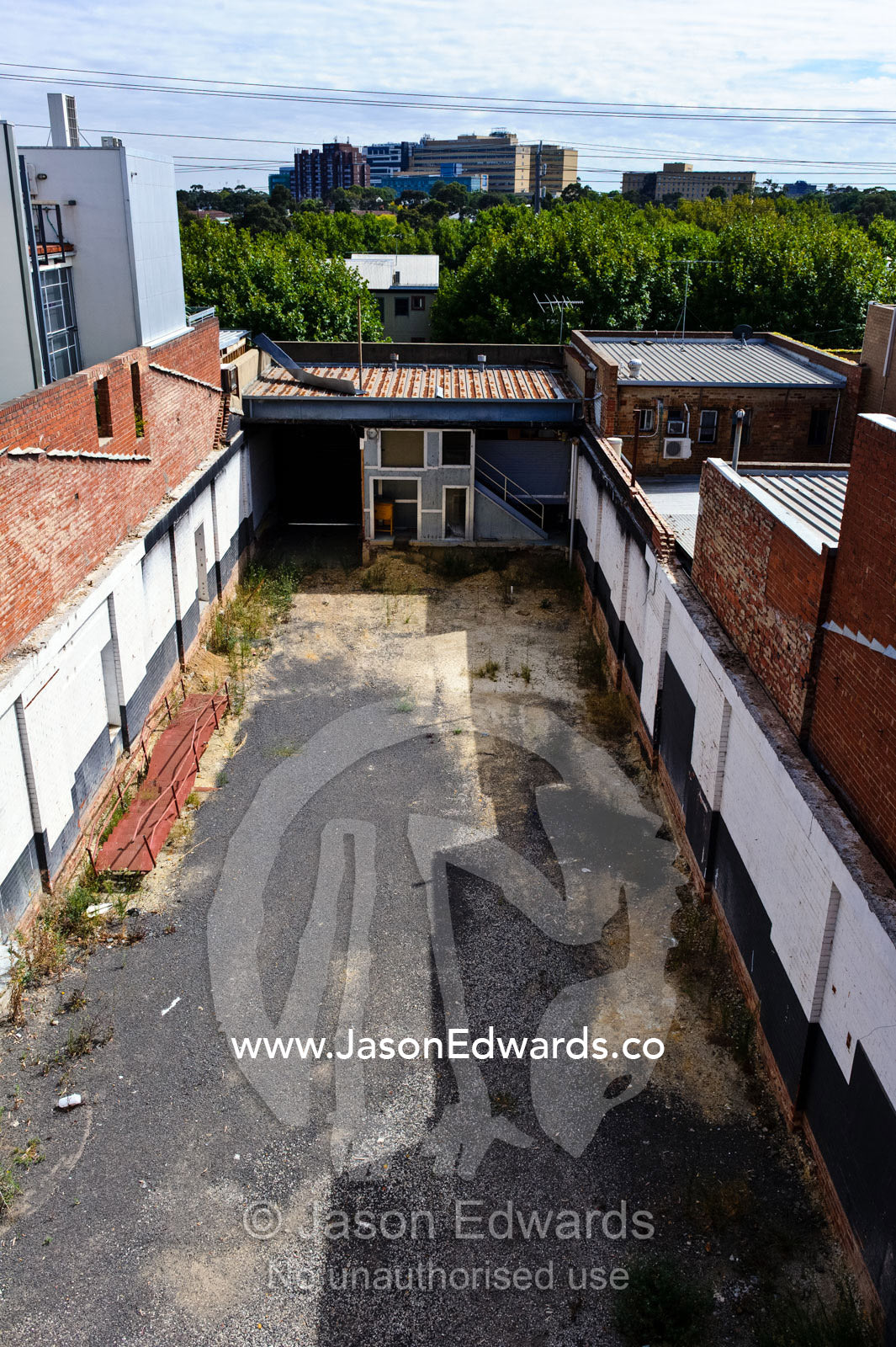 An abandoned block of land between warehouses in an inner city suburb. North Melbourne, Melbourne, Victoria, Australia.