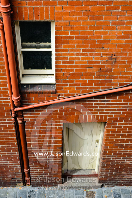 Looking down on the rear window and backdoor of a city warehouse. North Melbourne, Melbourne, Victoria, Australia