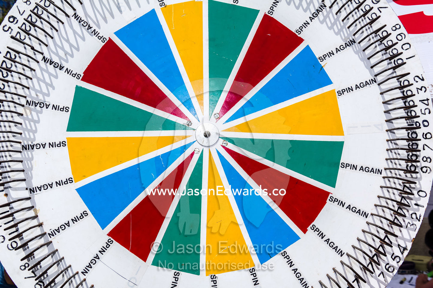 A colourful spinning wheel awards prizes at a school fete fundraiser. Carlton North, Melbourne, Victoria, Australia