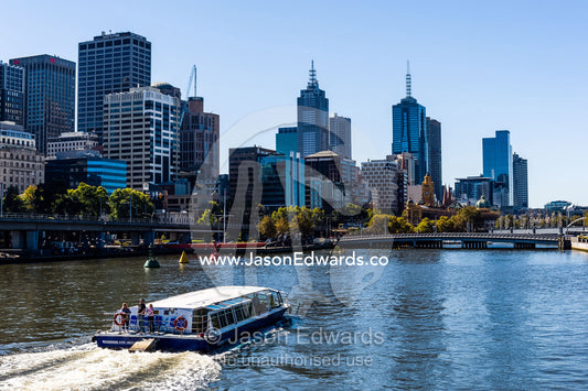 A water taxi carries tourists sightseeing along the Yarra River. Yarra River, Melbourne, Victoria, Australia.