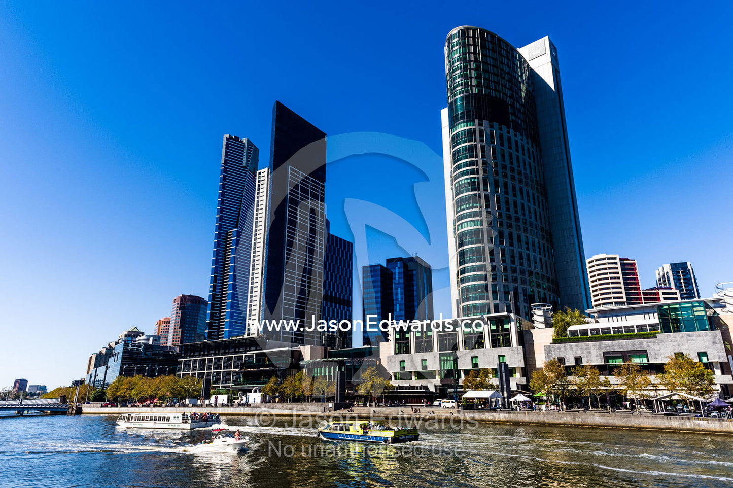 A water taxi carries tourists sightseeing along the Yarra River. Yarra River, Crown Casino, Southbank, Melbourne, Victoria, Australia.