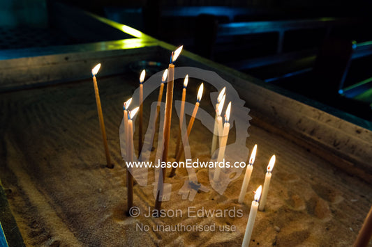 Prayer candles await worshippers in a quiet Greek Orthodox church. St Andrews Greek Orthodox Church, Melbourne, Victoria, Australia.