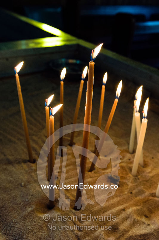 Prayer candles await worshippers in a quiet Greek Orthodox church. St Andrews Greek Orthodox Church, Melbourne, Victoria, Australia.
