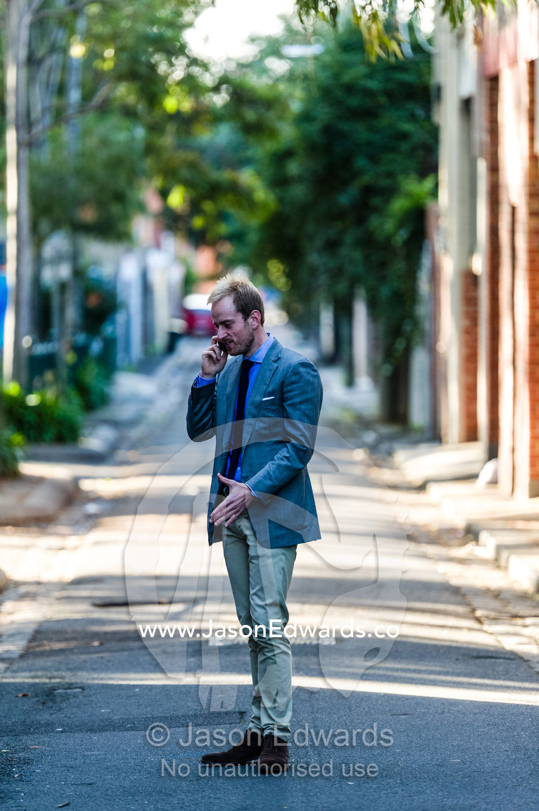 A real estate agent conducting a business meeting on a smart phone. Collingwood, Melbourne, Victoria, Australia.