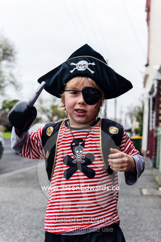 A young boy dresses as a wicked pirate giving a snarl. Carlton North, Melbourne, Victoria, Australia.