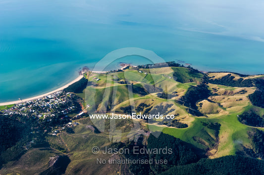 A tiny coastal town surrounded by farmland and rolling hills. Auckland, New Zealand.