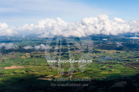 Lush rolling farmland stretching across New Zealand's north island. Auckland, New Zealand.