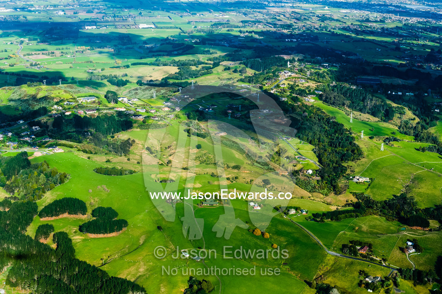 Lush rolling farmland stretching across New Zealand's north island. Auckland, New Zealand.