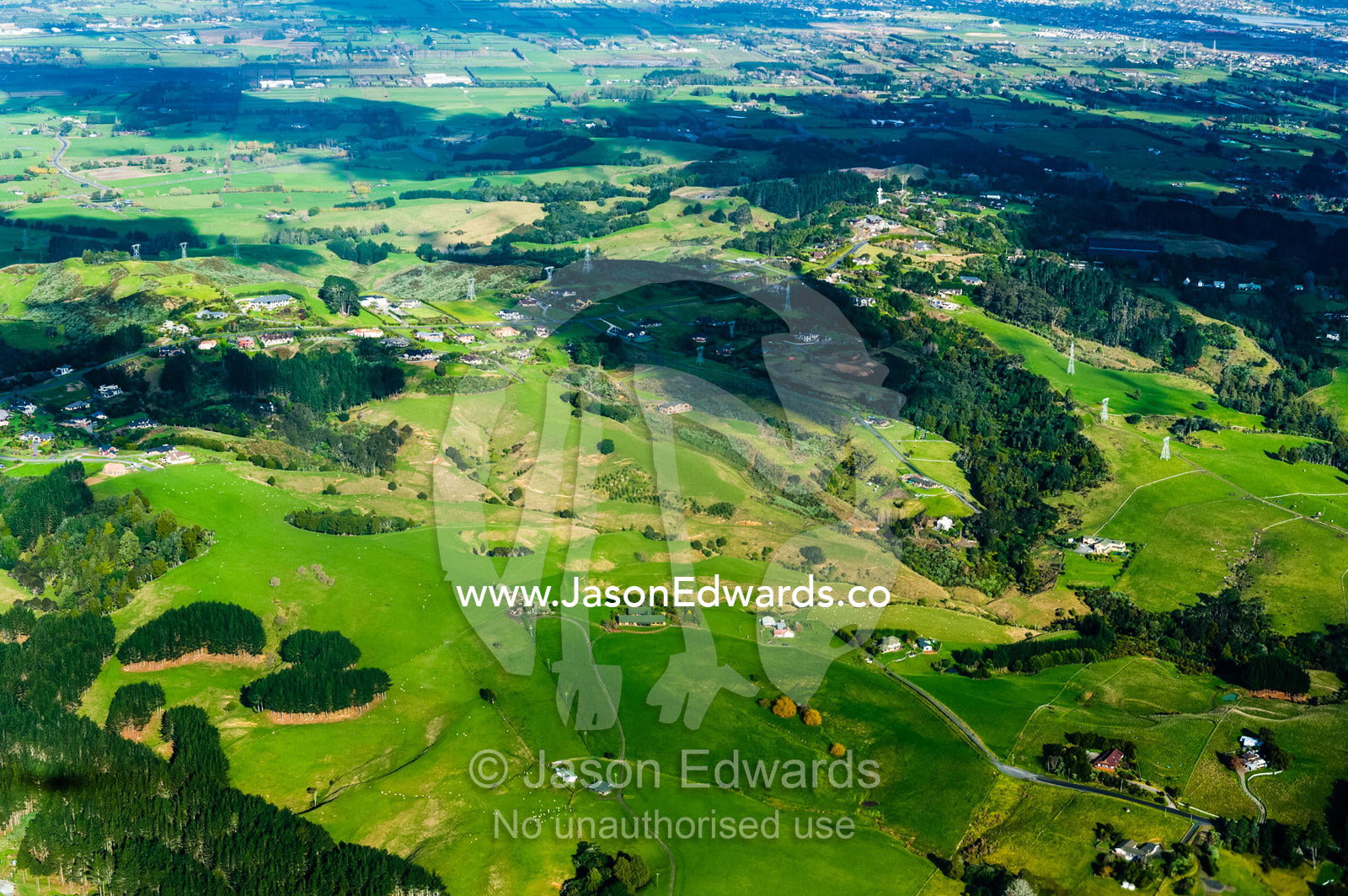 Lush rolling farmland stretching across New Zealand's north island. Auckland, New Zealand.