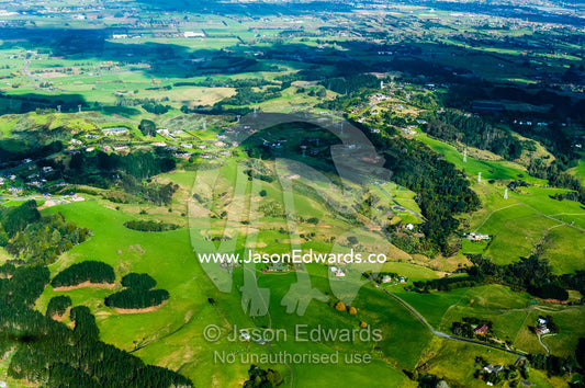 Lush rolling farmland stretching across New Zealand's north island. Auckland, New Zealand.