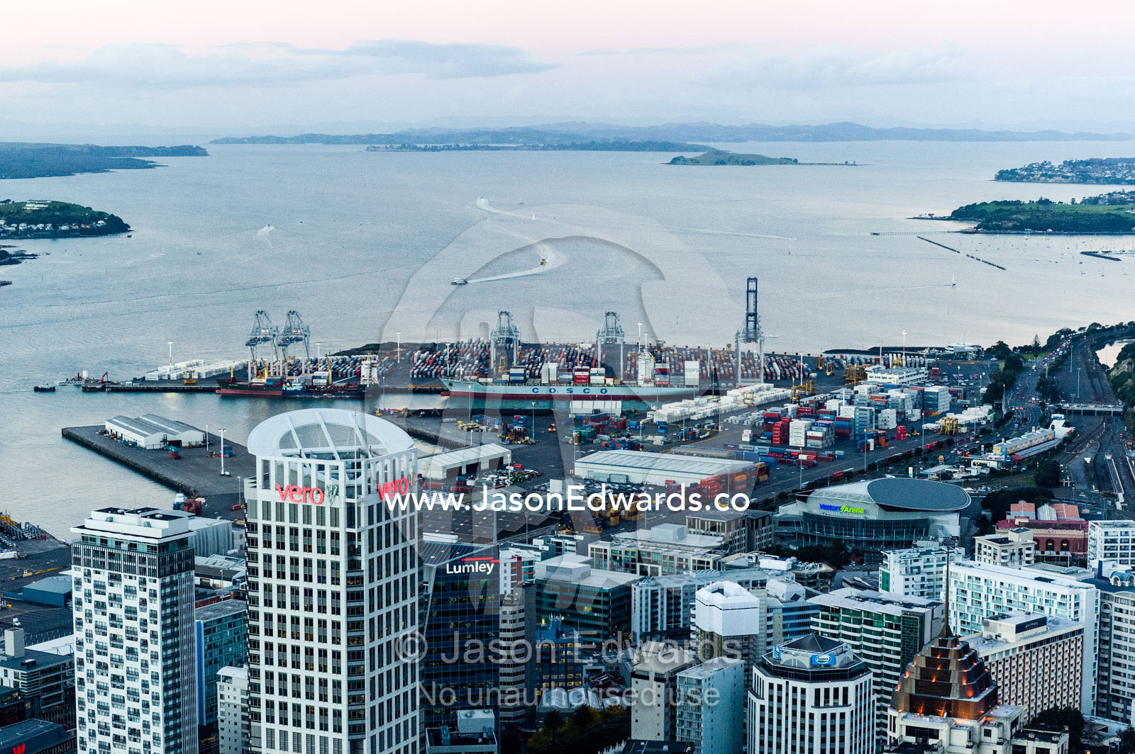 Looking over a city skyline and industrial shipping port to the sea. Half Moon Bay, Waitemata Harbour, Auckland City, Aukland, New Zealand.